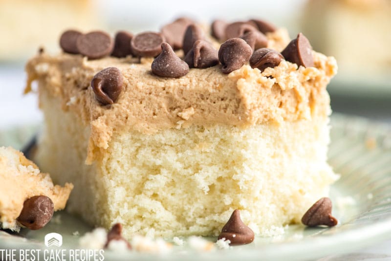 a piece of cake with peanut butter frosting and chocolate chips