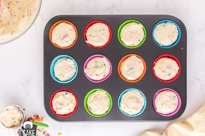 unbaked fruity pebble cupcakes in a pan