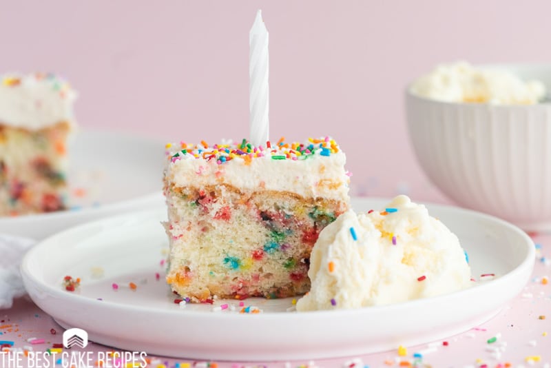 a piece of birthday cake on a plate with a candle