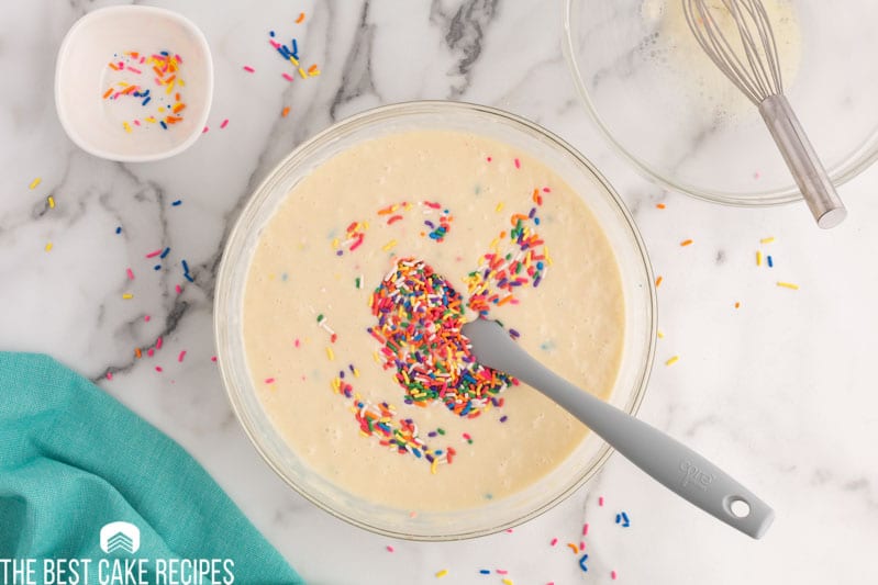 sprinkles in a bowl of a cake batter