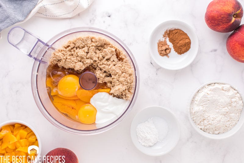 wet ingredients for peach bread in a food processor