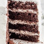 a 4 layer chocolate cake with one slice missing