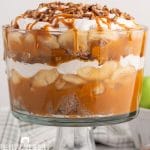 a large trifle bowl with apples, spice cake and butterscotch
