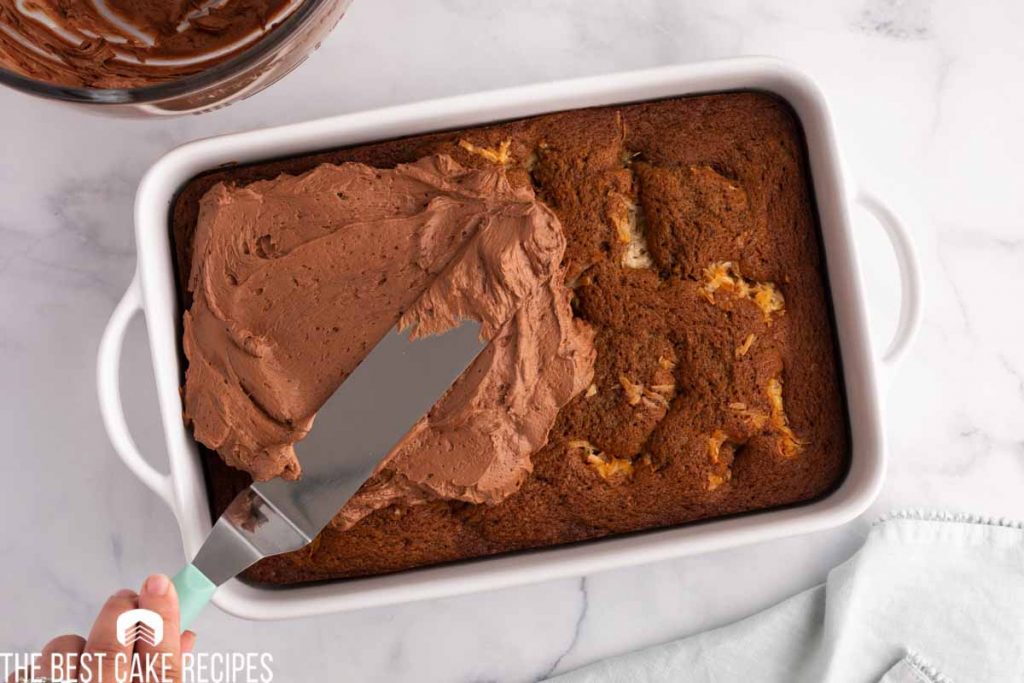 chocolate frosting spread on a cake