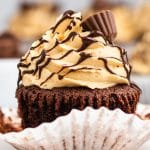 an unwrapped chocolate cupcake on a table