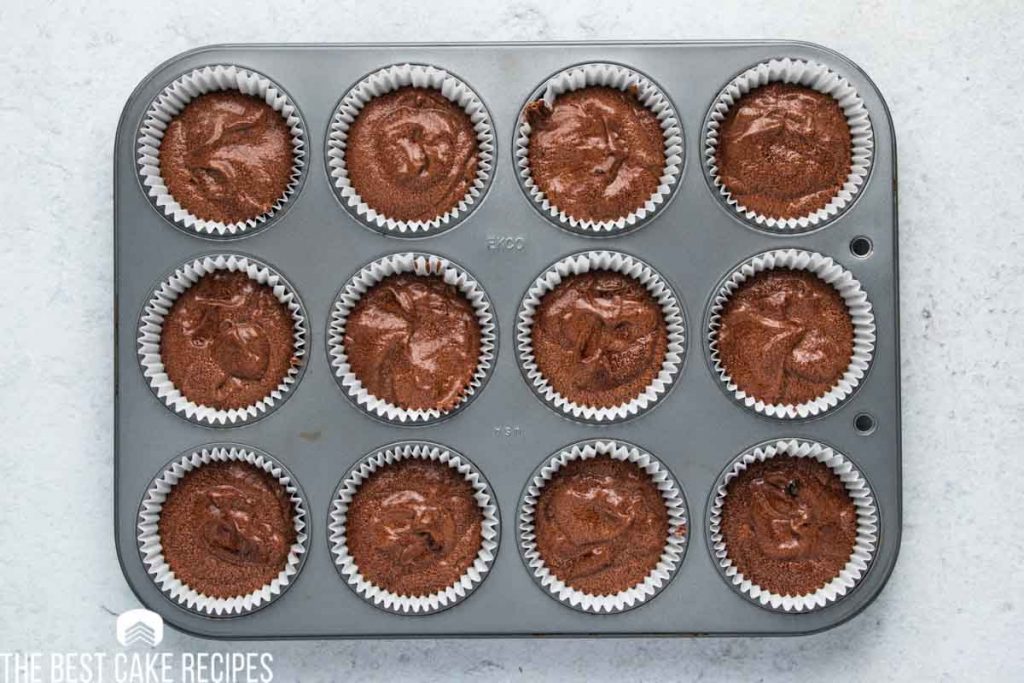 unbaked chocolate cupcakes in a muffin pan