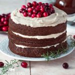 a three layer christmas spice cake with cranberries on top