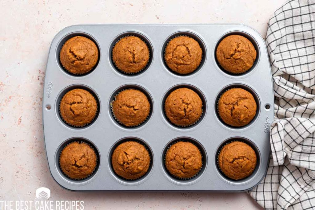 baked pumpkin cupcakes in a muffin pan