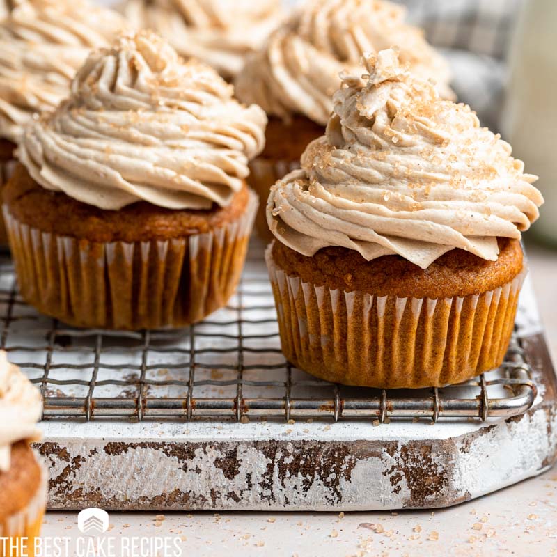 pumpkin spice latte cupcakes sitting on a wire rack