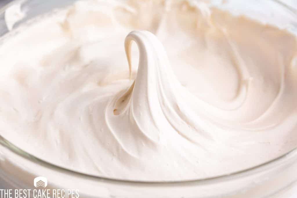 stiff peaked whipped frosting in a bowl
