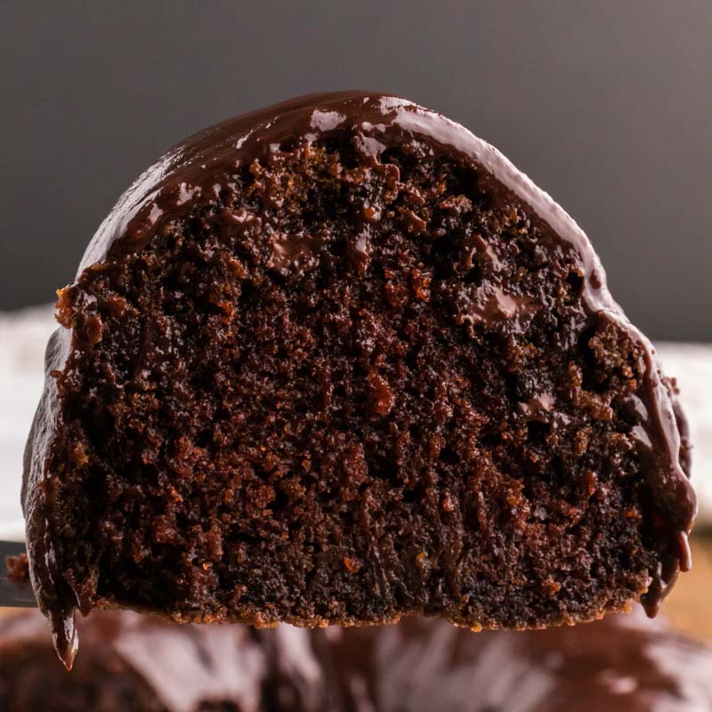 a piece of chocolate bundt cake with chocolate glaze