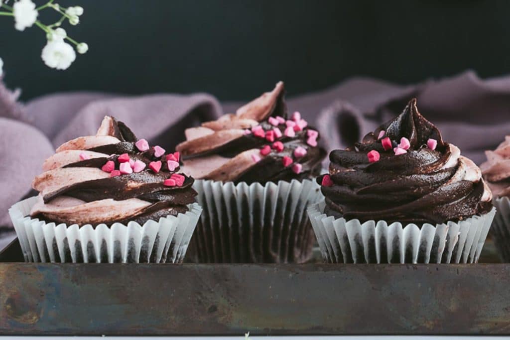 chocolate strawberry swirled cupcakes on a tray