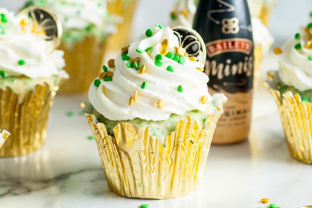 st patrick's day cupcake with a gold coin and sprinkles