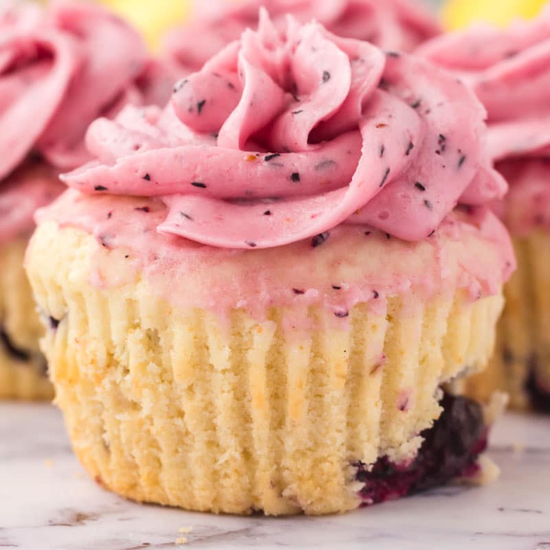 closeup of a lemon blueberry cupcake with a swirl of frosting
