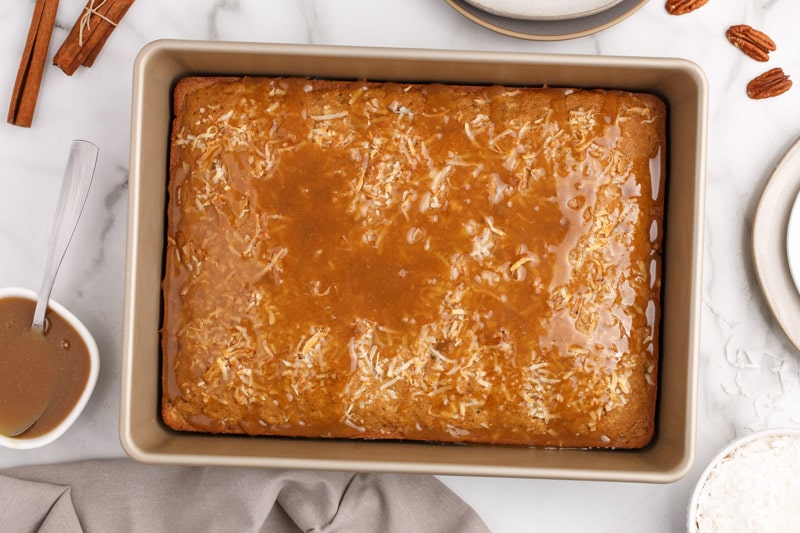 overhead view of a coconut spice cake with caramel on top