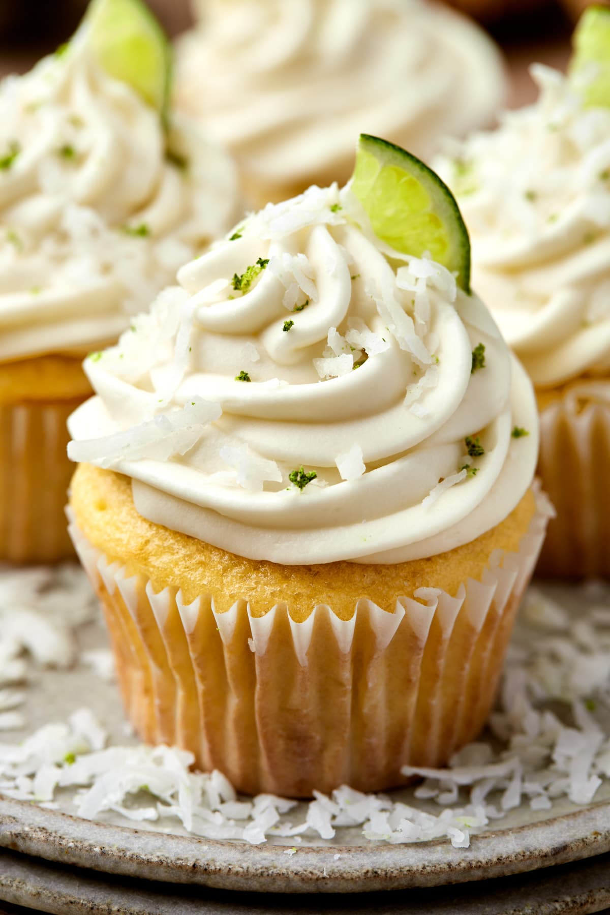 a cupcake with cream cheese lime frosting and coconut