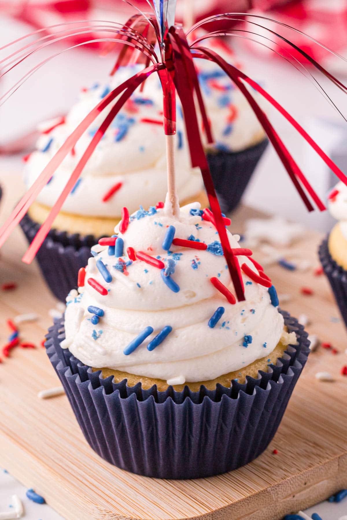 a cupcake with a firecracker toothpick on top