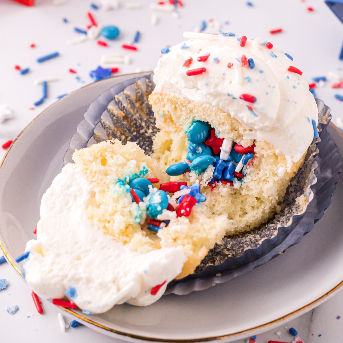 july 4th cupcakes filled with sprinkles on a plate
