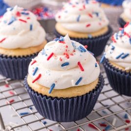 cupcake with white frosting and patriotic sprinkles