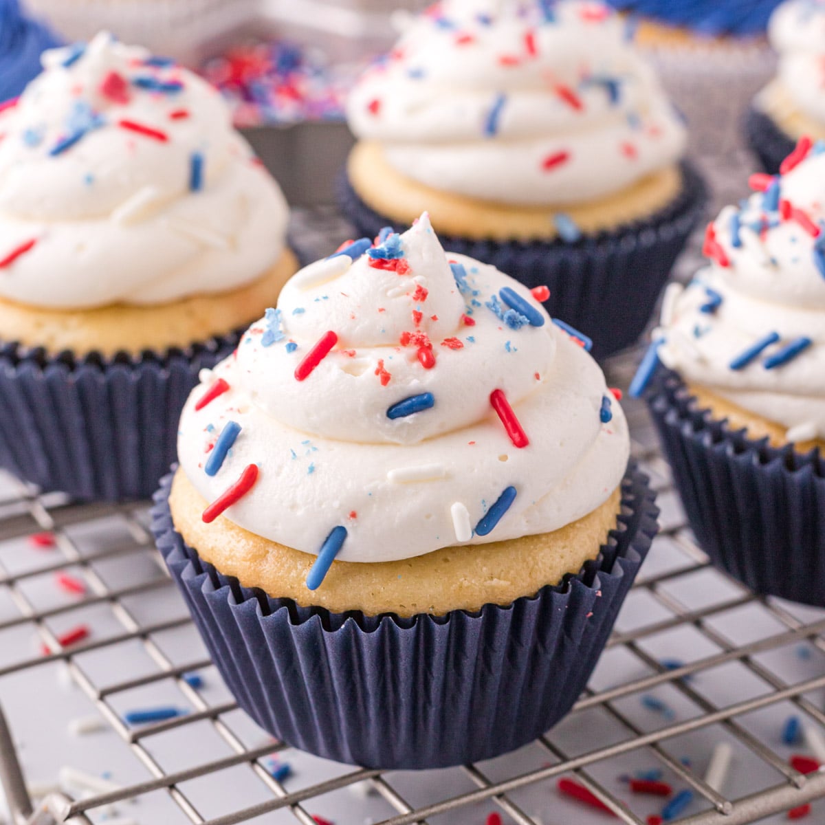 cupcake with white frosting and patriotic sprinkles