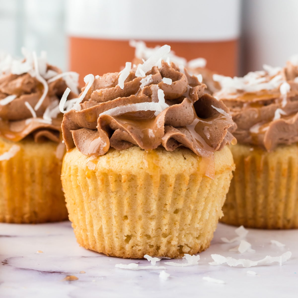 a samoa cupcake with chocolate frosting and coconut