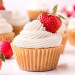 vanilla cupcake with vanilla frosting and a strawberry