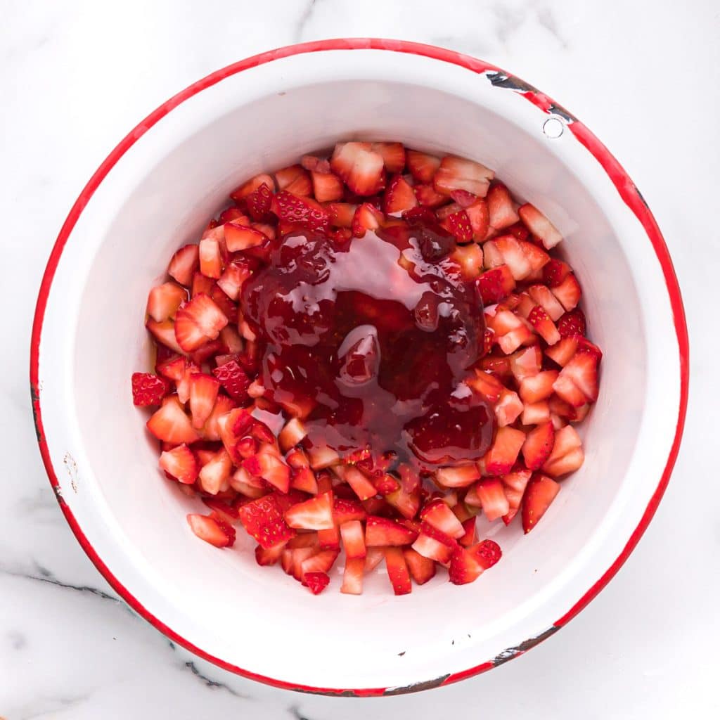 strawberries, jam and honey in a bowl
