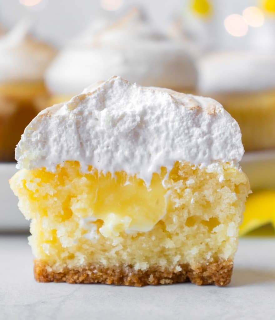 half of a lemon meringue cupcake on a table