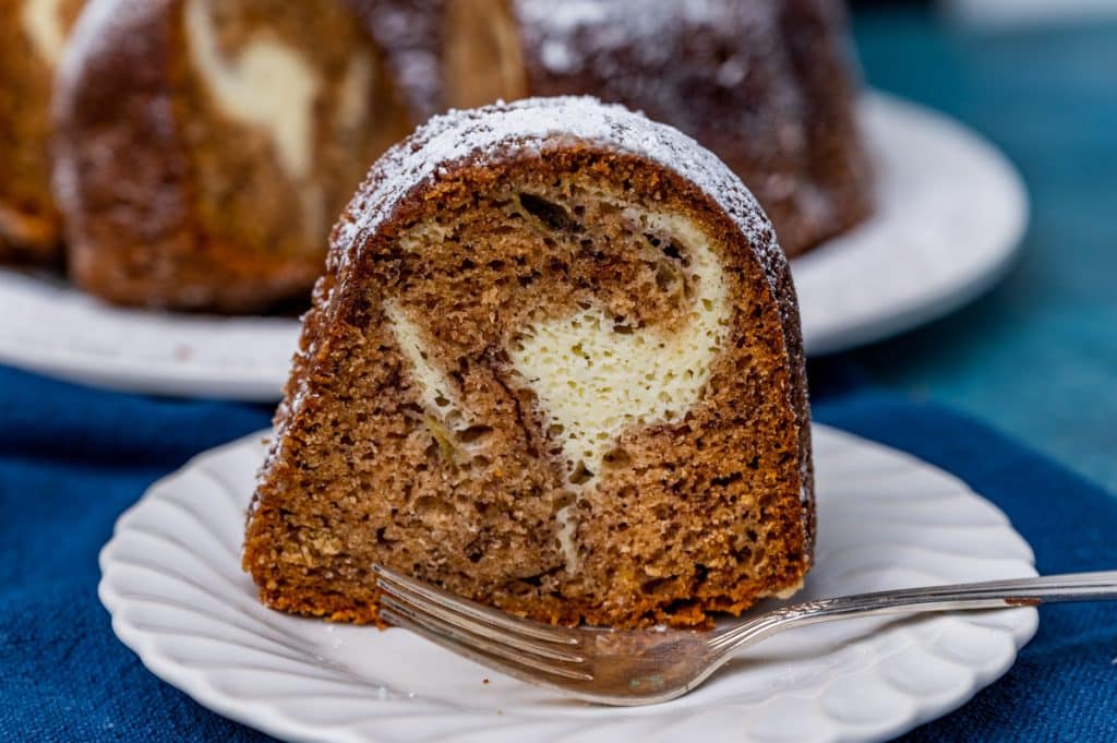 a piece of banana bundt cake on a plate with a fork