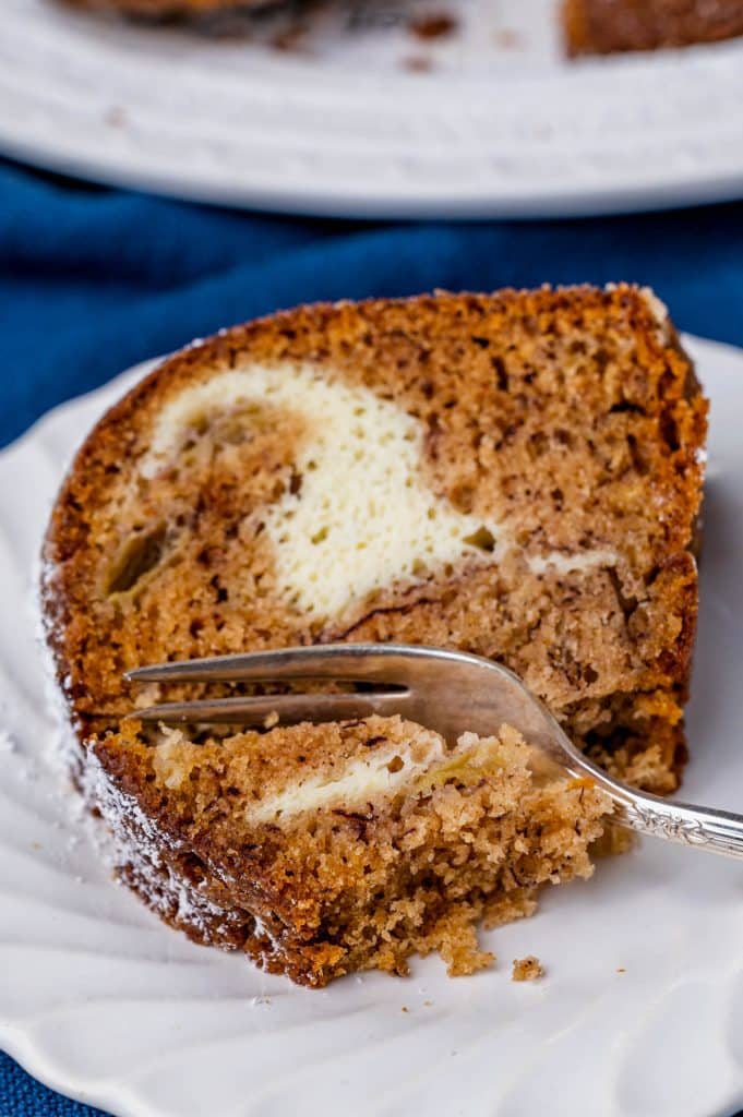 a slice of banana bundt cake on a plate with a fork
