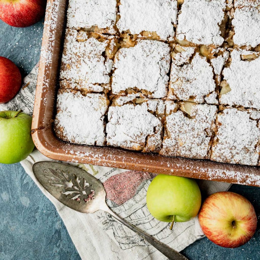 overhead view of apple walnut snack cake with powdered sugar