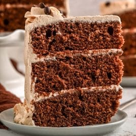 a 3 layer slice of cake sitting on a plate