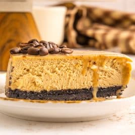 a piece of glazed coffee cheesecake with oreo crust