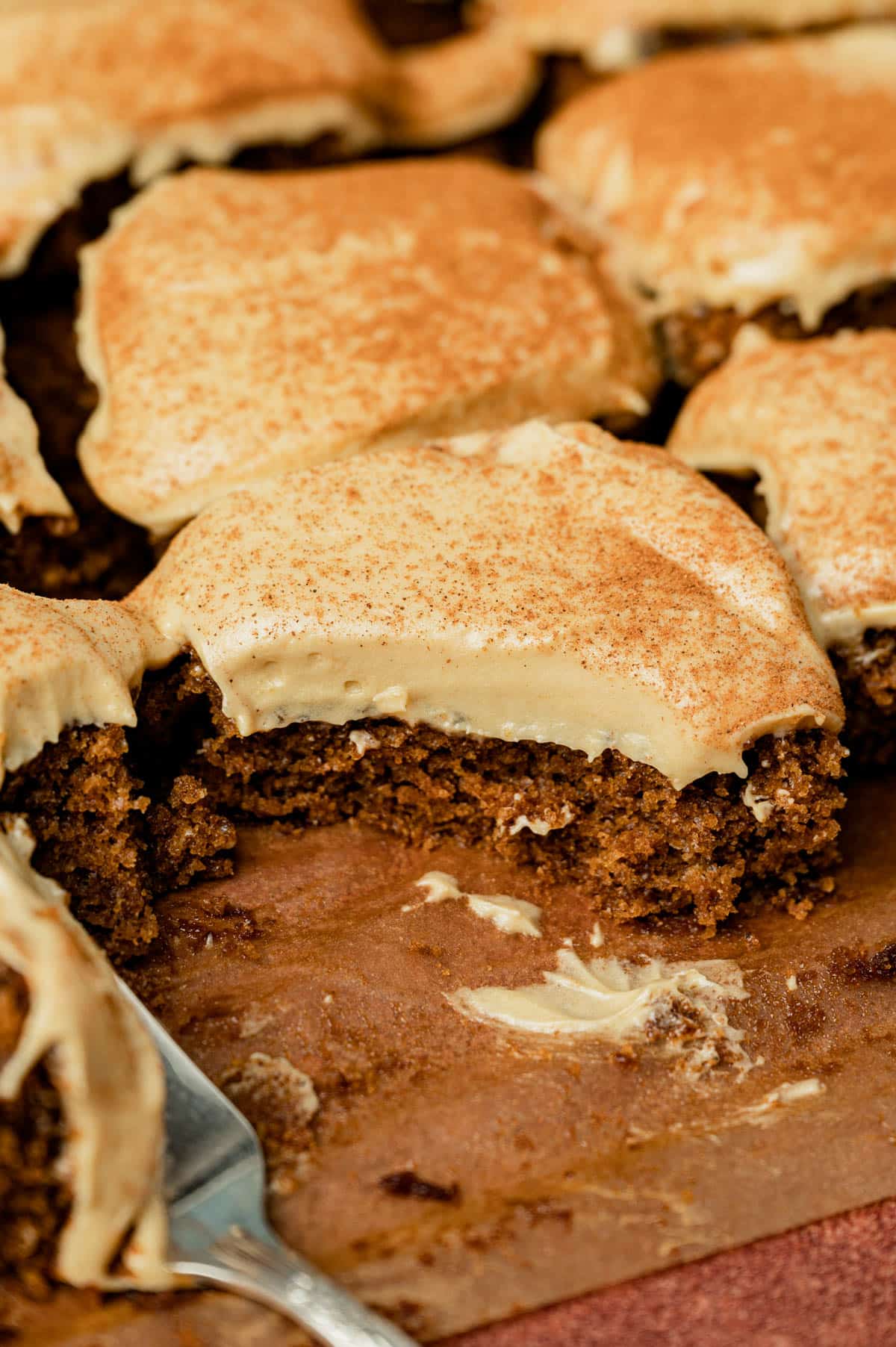 frosted gingerbread sheet cake cut into squares