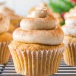 a frosted ginger spice cupcake sitting on a cooling rack