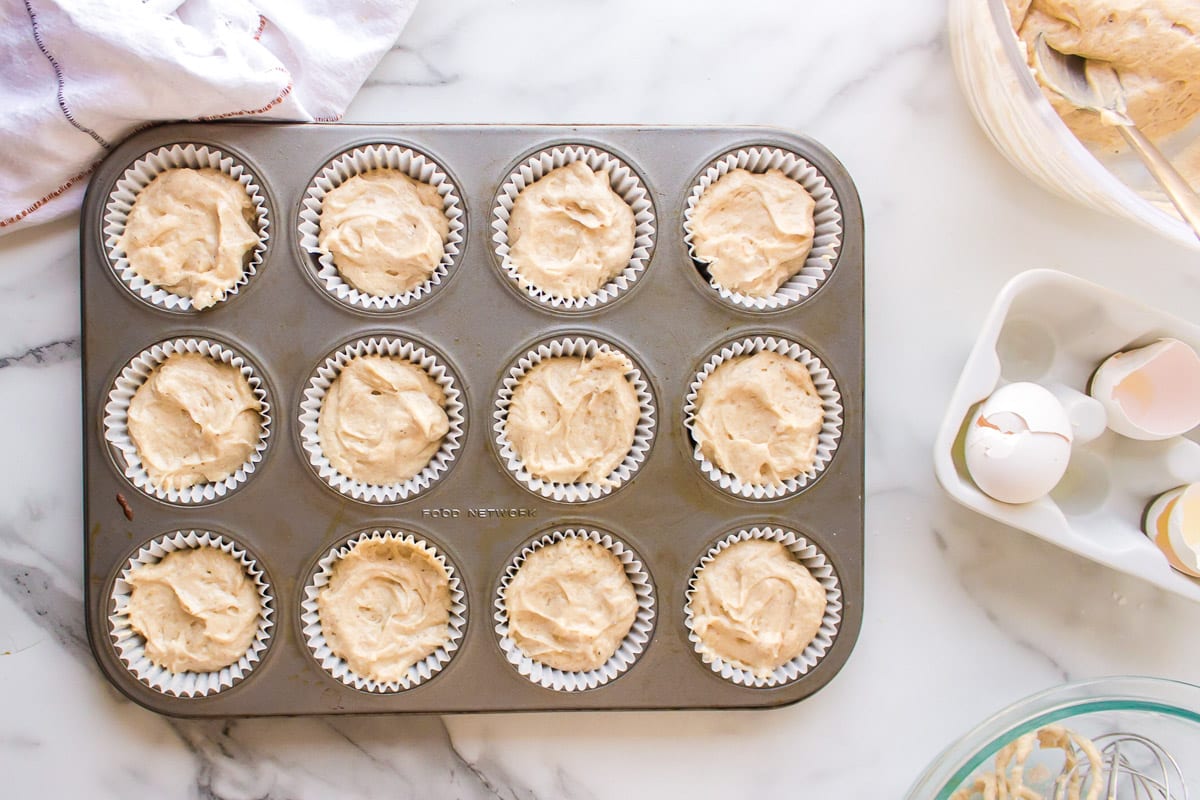 unbaked cupcakes sitting on a table in a muffin pan