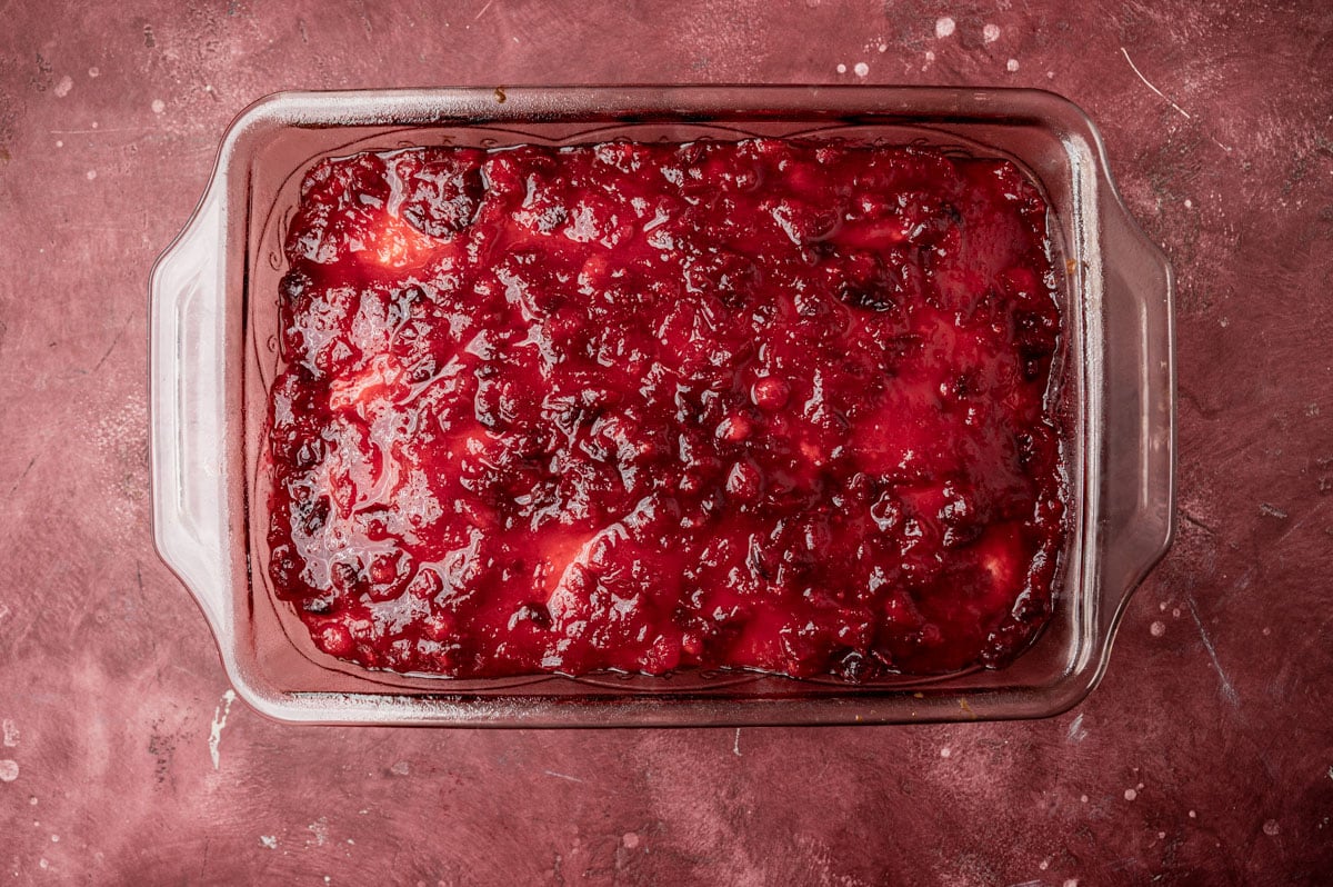white cake with cranberry sauce over the top