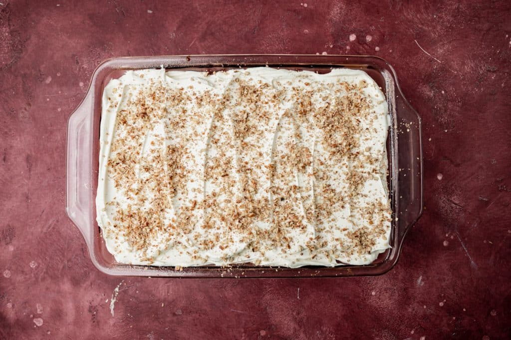 a cake with chopped nuts in a baking pan