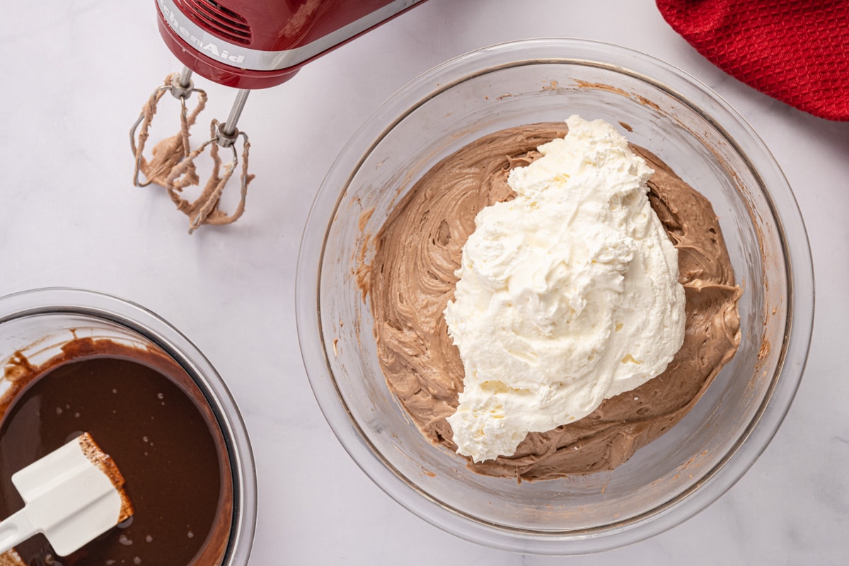 whipped cream on top of chocolate cream cheese filling