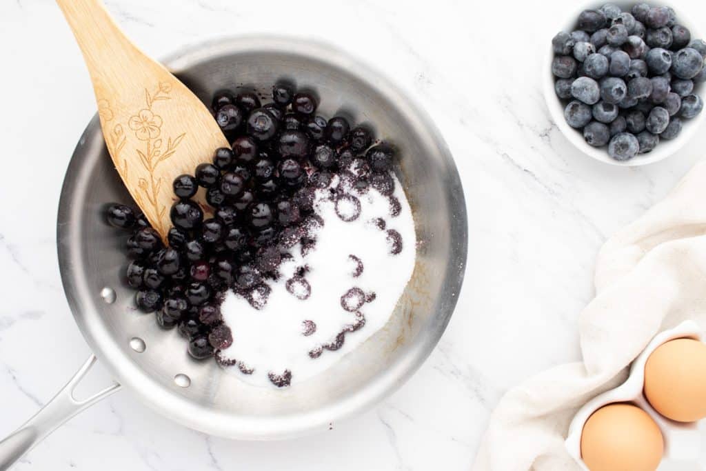 blueberries and sugar in a saucepan