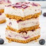 a stack of three blueberry cheesecake bars