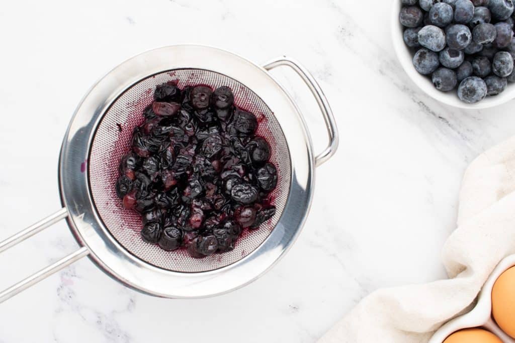 cooked blueberries in a strainer