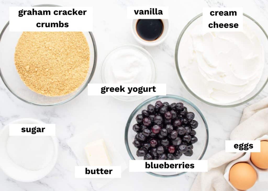 ingredients for blueberry cheesecake bars on a table