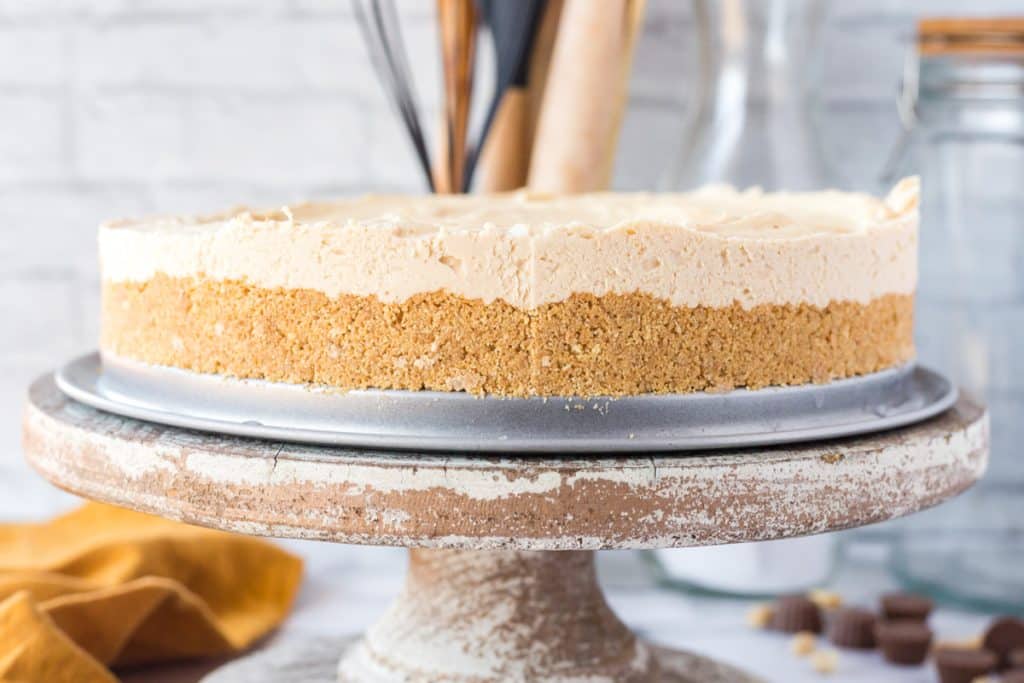 a peanut butter cheesecake on a cake plate