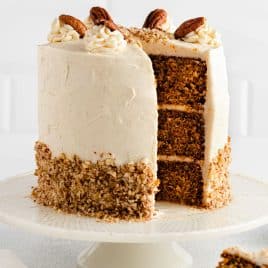 a ginger carrot cake on a plate with one piece missing