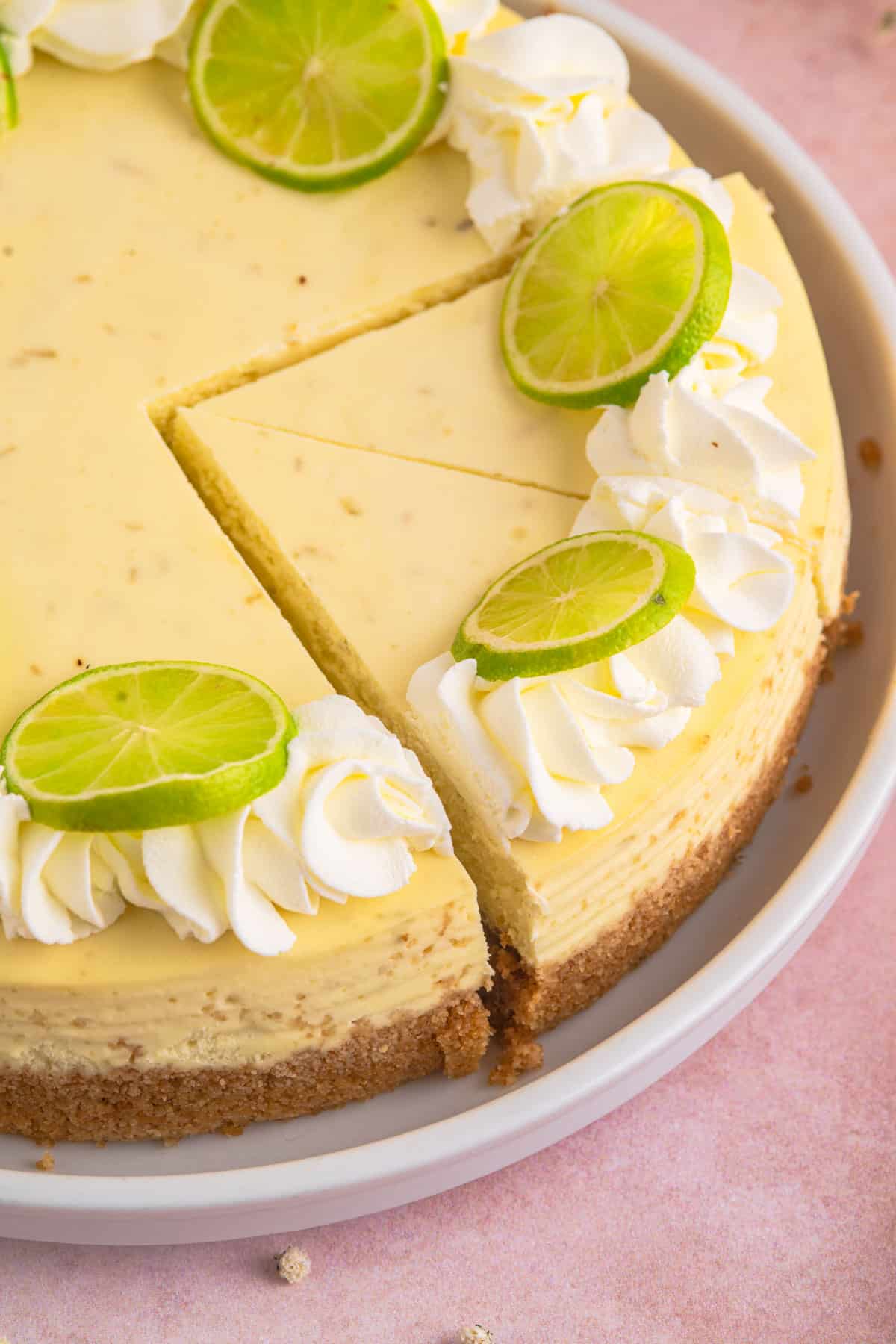 lime cheesecake cut in two slices on a plate