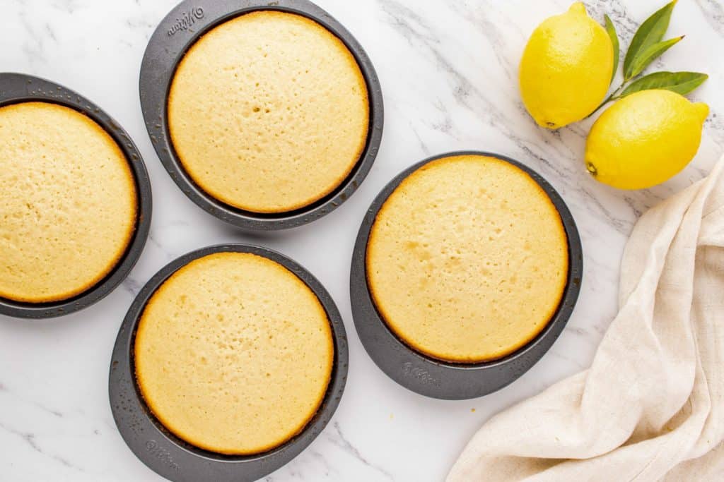 4 lemon cake layers in pans