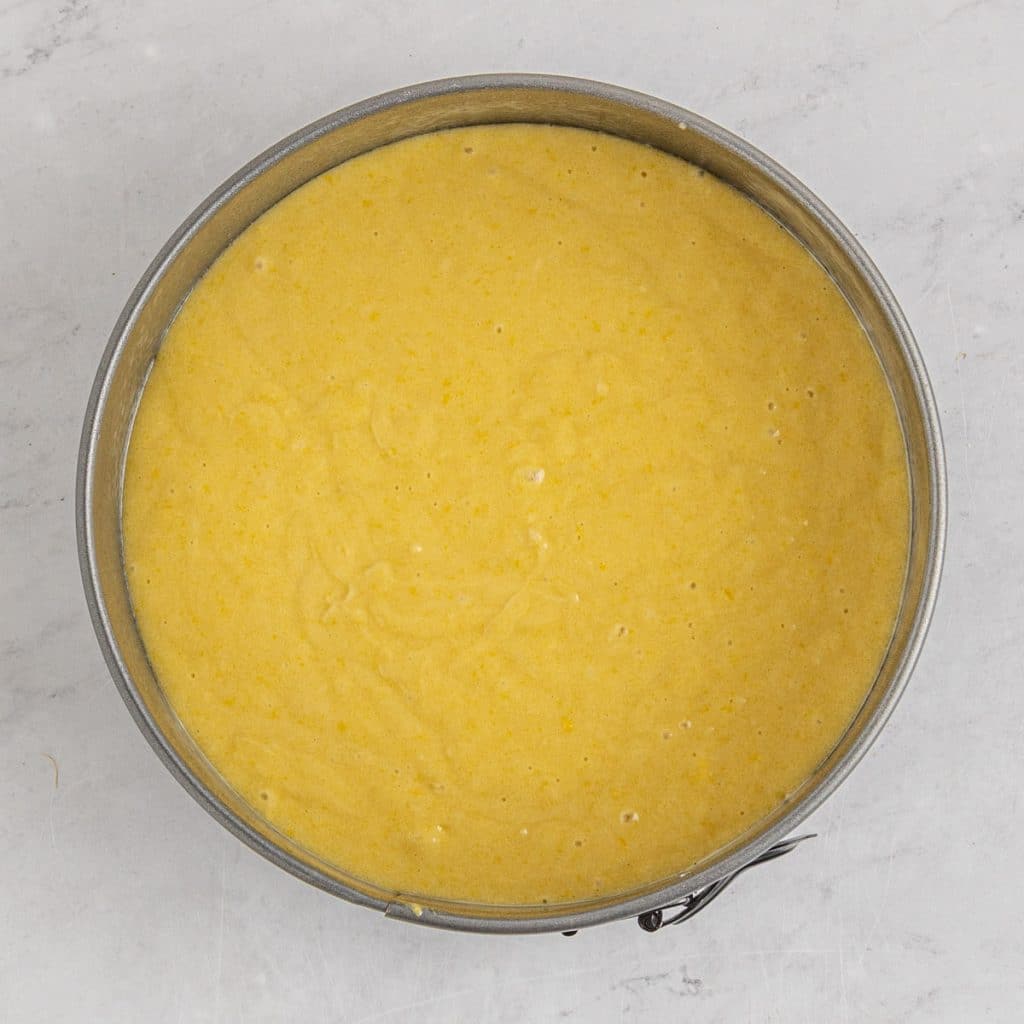 unbaked lemon cake in a springform pan