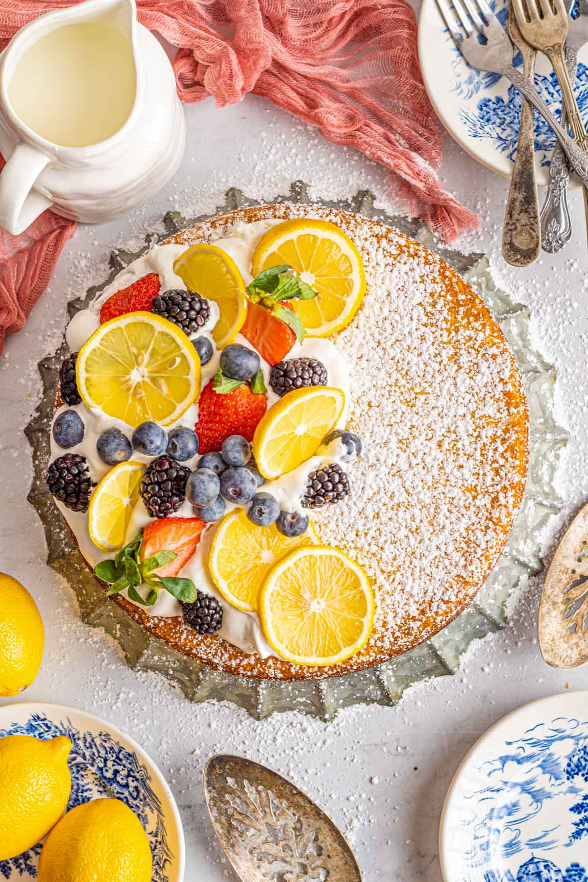 lemon olive oil cake with fresh fruit on a table