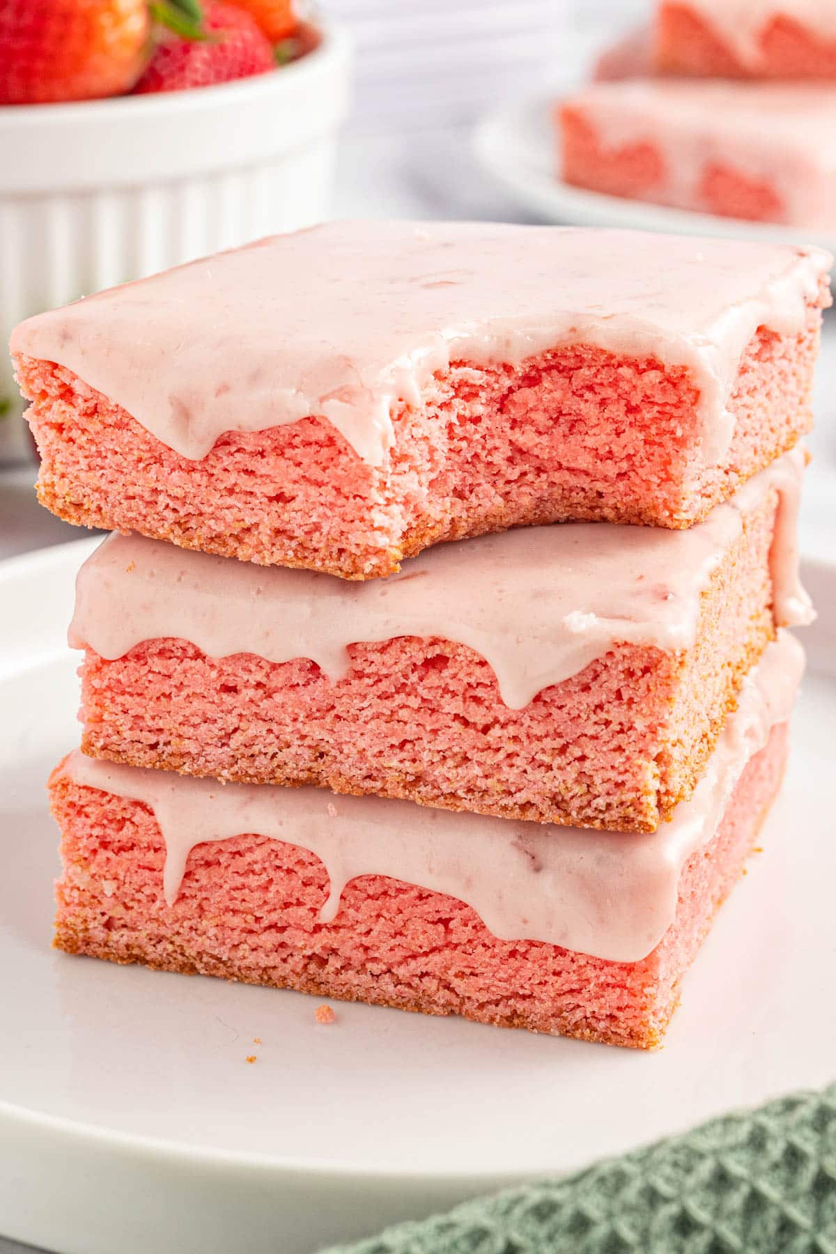 a stack of three strawberry brownies, one with a bite out of it
